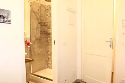 a bathroom with a shower with a glass door at Cosmo Apartment in Palermo