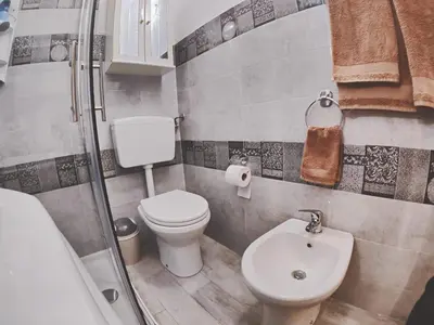 a bathroom with a toilet and a sink and a shower at Casa vacanza Terra Mare in Castellammare del Golfo