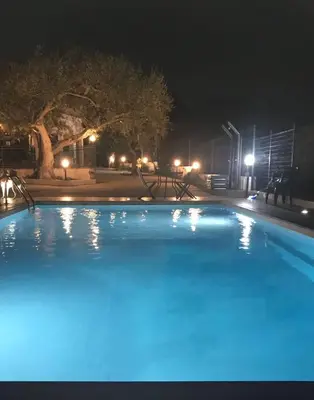 a swimming pool at night with blue illumination at Villa Mazzamuto in Altavilla Milicia