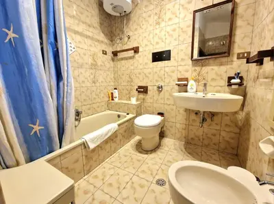 a bathroom with a sink and a toilet and a tub at Villa Mazzamuto in Altavilla Milicia