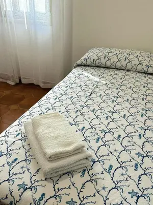 a bed with two towels sitting on top of it at Villa Mazzamuto in Altavilla Milicia
