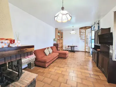 a living room with a couch and a fireplace at Villa Mazzamuto in Altavilla Milicia