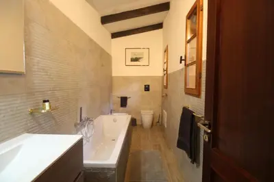 a bathroom with a tub and a sink and a toilet at Villa Rosa Bianca in Palermo