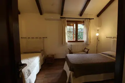a bedroom with two beds and a window at Villa Rosa Bianca in Palermo