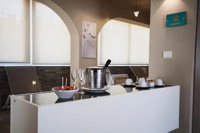 a kitchen with a island with a counter top at Principe Alogna Hotel & SPA in Altavilla Milicia