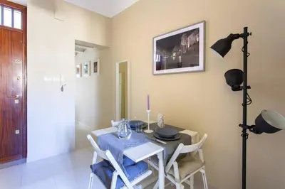 a dining room with a table and chairs and a television at Da Mari e Paolo in Palermo