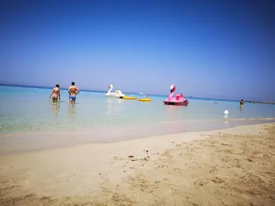 a group of people in the water at the beach at Casa vacanza da Samuele in San Vito lo Capo