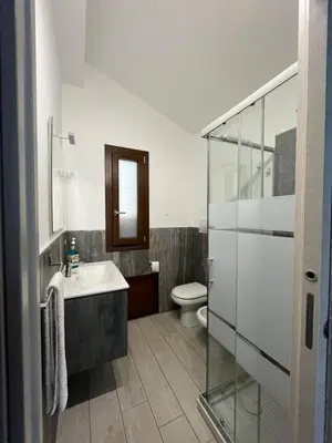 a bathroom with a sink and a toilet at Villa Futura in Scopello