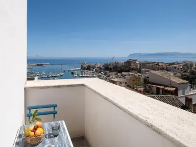 a basket of fruit sitting on a table on a balcony at Tannur B&B in Castellammare del Golfo