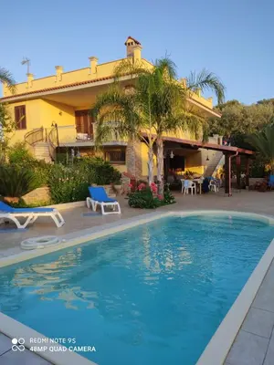 a house with a swimming pool in front of a house at Villa Summer in Trappeto