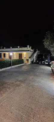 a parking lot in front of a building at night at Villa Summer in Trappeto