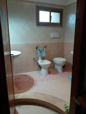 a bathroom with a toilet and a sink at Villa Summer in Trappeto