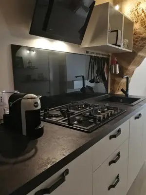 a kitchen counter with a stove and a toaster at Cesare Home in Palermo