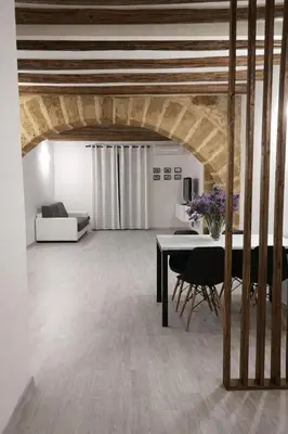 a living room with a table and a couch at Cesare Home in Palermo