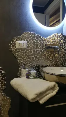 a bathroom with a sink and a mirror at Cesare Home in Palermo