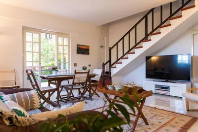 a living room with a couch and a table with a tv at Casa Pitea in Mondello