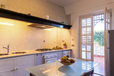 a kitchen with a bowl of fruit on a table at Casa Pitea in Mondello