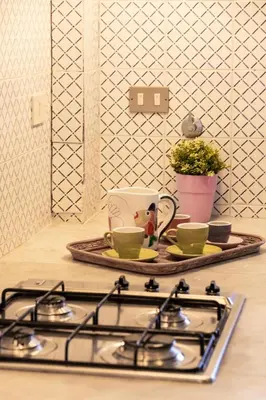 a stove top with two cups and a tray on a counter at Casa Pitea in Mondello