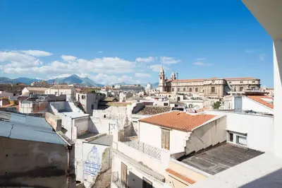 a street in a city with buildings and potted plants at Cassaro Apartment con Terrazza by Wonderful Italy in Palermo