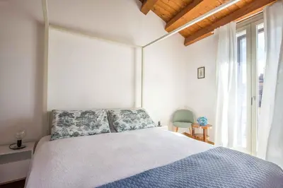 a living room with a blue couch and a table at Cassaro Apartment con Terrazza by Wonderful Italy in Palermo