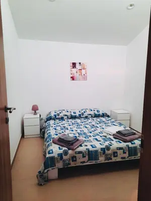 a bedroom with a bed with a quilt on it at VILLA MOGUNTIA in Ficarazzi
