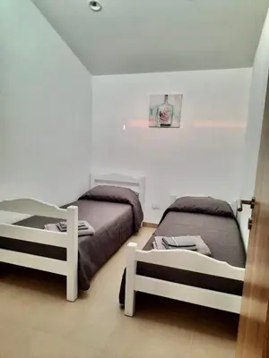 a bedroom with two beds at VILLA MOGUNTIA in Ficarazzi