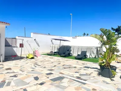 a patio with two chairs and an umbrella and a tent at VILLA MOGUNTIA in Ficarazzi