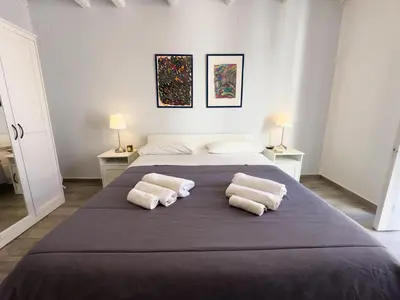 a bedroom with a large bed with two pillows at Appartamenti Maria Al Capo in Palermo