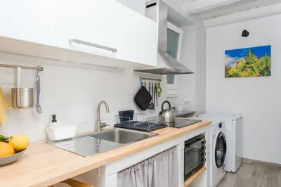 a kitchen with a sink and a washing machine at Appartamenti Maria Al Capo in Palermo