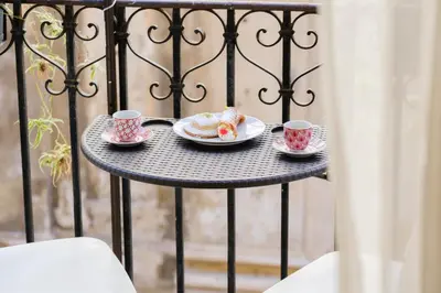 a table with two cups and plates of food at Appartamenti Maria Al Capo in Palermo