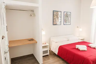 a bedroom with a bed with a red blanket at Appartamenti Maria Al Capo in Palermo