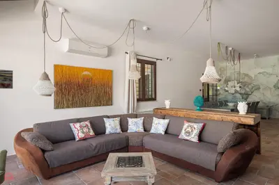 a living room with a couch and a table at Meravigliosa Villa a Trappeto vicino al mare in Trappeto