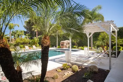 a swimming pool with a palm tree and a pavilion at Meravigliosa Villa a Trappeto vicino al mare in Trappeto
