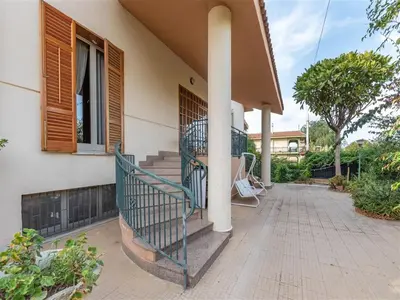 a porch of a house with a green railing at Villa with Pool, Pets & WiFi in Misilmeri