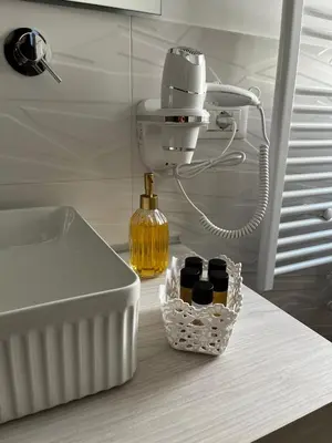 a kitchen counter with a sink and a bottle of oil at Carpe Diem Rooms by Marino Tourist in Palermo