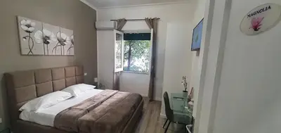 a bedroom with a bed and a window and a desk at Carpe Diem Rooms by Marino Tourist in Palermo