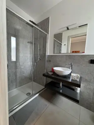 a bathroom with a sink and a shower at Solus b&b in Casteldaccia