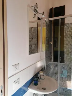 a bathroom with a sink and a mirror at Appartamento Kardía in Palermo