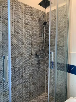 a bathroom with a shower with a glass door at Appartamento Kardía in Palermo