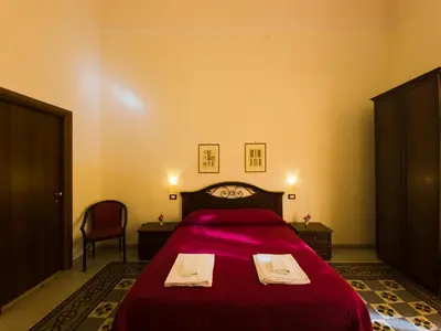 a bedroom with a bed with two towels on it at B&B Liberty in Palermo