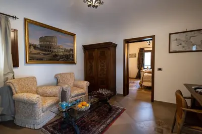 a living room with two chairs and a table at Villa del Gattopardo in Palermo