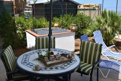 a table with two chairs and a table with a table at In Riva al Mare da Franca in Trabia
