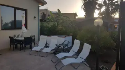 a group of chairs and a table in a yard at In Riva al Mare da Franca in Trabia