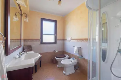 a bathroom with a toilet and a sink and a shower at Panoramica Villa con Piscina sul Mare (Sanificata) in Cinisi