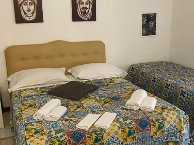a bed with two twin beds with towels on it at Alba central City in Palermo