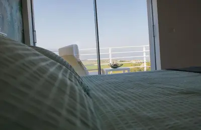 a bedroom with a bed and a large window at Case Playa Resort Balestrate in Balestrate