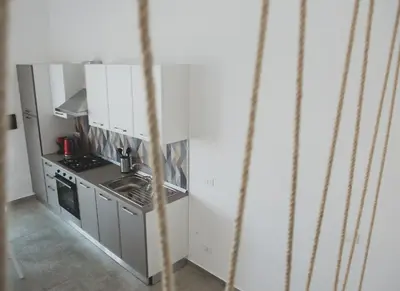 a small kitchen with a sink and a stove at Case Playa Resort Balestrate in Balestrate