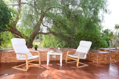 two chairs and a table on a patio at Villa Trappeto in Trappeto
