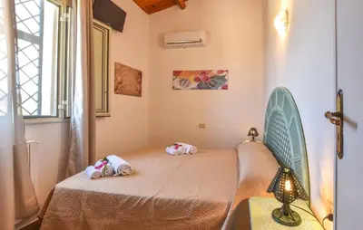 a bedroom with a bed with two stuffed animals on it at Villa Trappeto in Trappeto