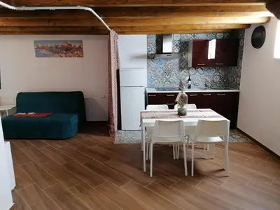 a kitchen and dining room with a table and chairs at Case Vacanze Azzurra, Loredana e Trinacria in Castellammare del Golfo